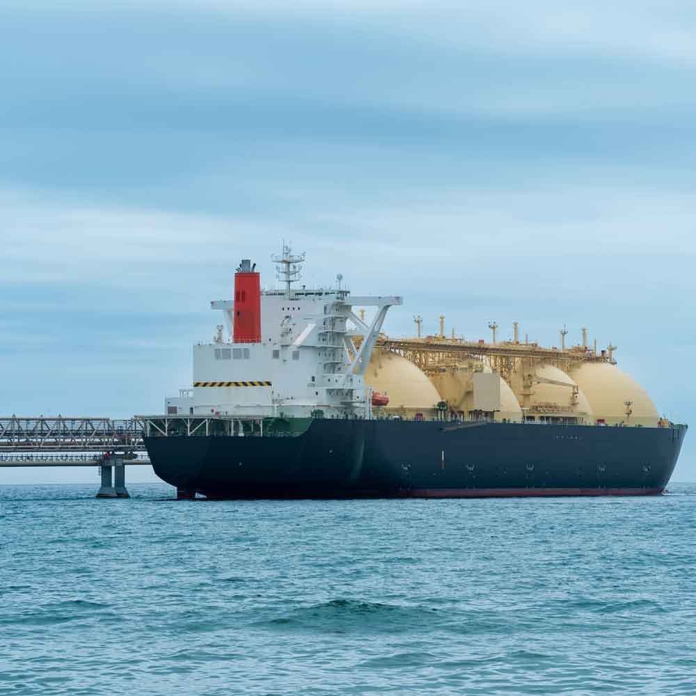 An LNG carrier alongside a loading jetty.