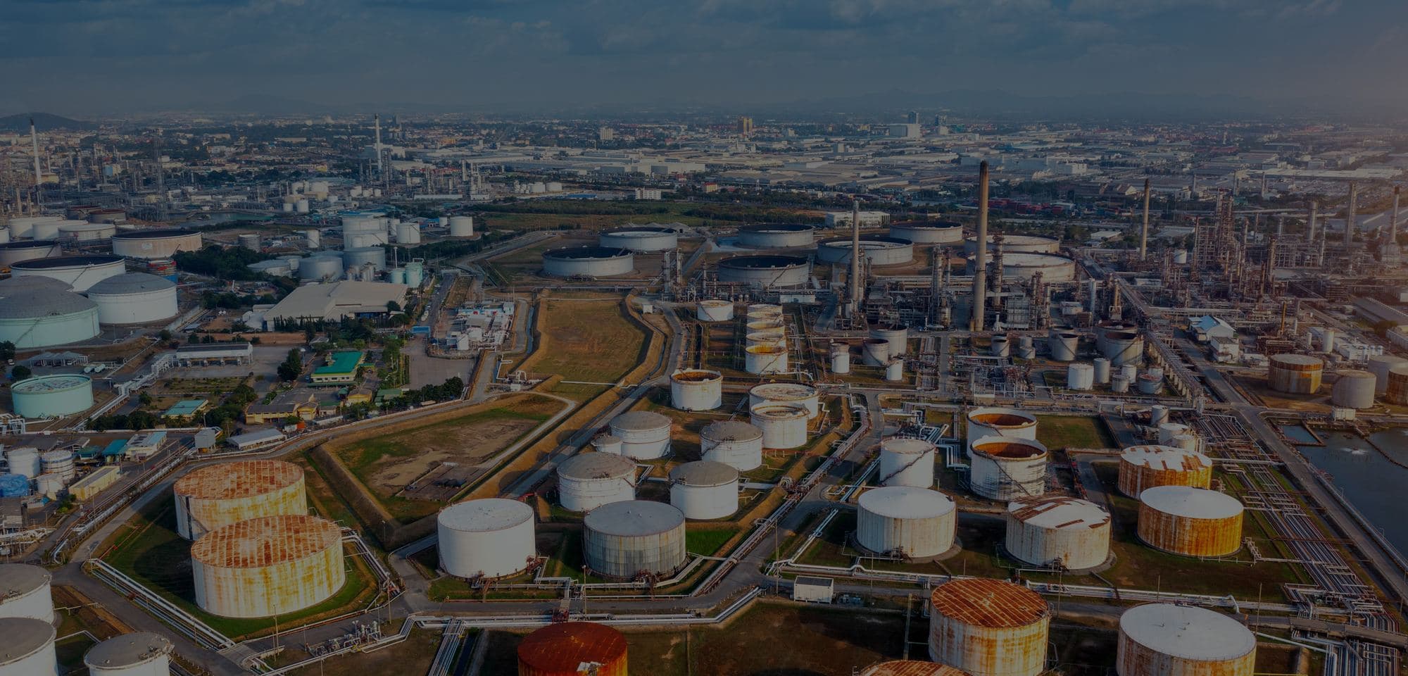 Aerial view of a coastal tank farm and refinery.